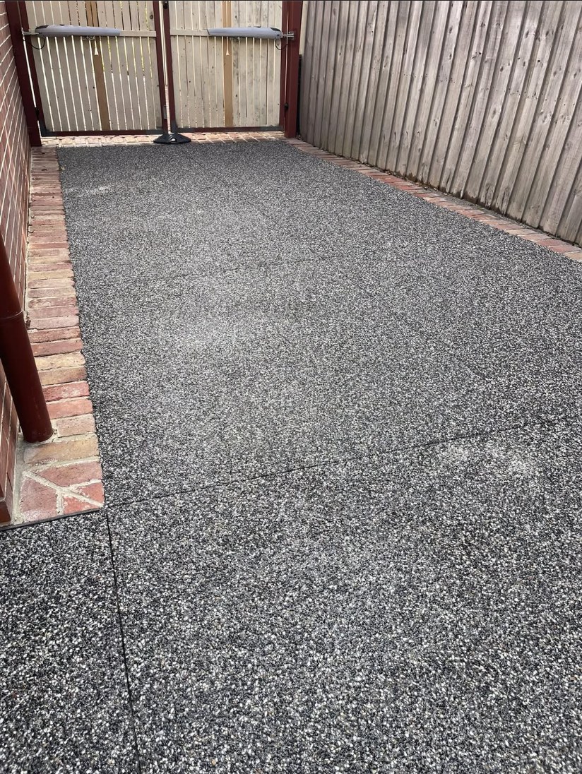 Salt and Pepper charcoal concrete courtyard with brick edging